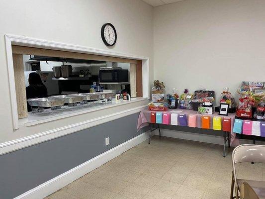 Corner area near the kitchen for serving food or using area for prizes.