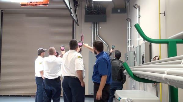 Students learning thermal imaging in Total Tech's Electrical Fundamentals class.