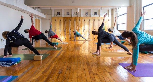 Students practicing extended side angle pose