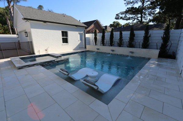 Luxury swimming pool with tanning ledge & ledge  loungers in Old Metairie.