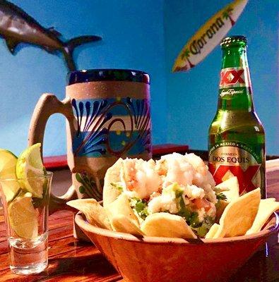 House Ceviche topped with Jumbo Shrimp accompanied with a cold beer uniquely served in a mud Clay Jar. Only At Cerviche Bar!