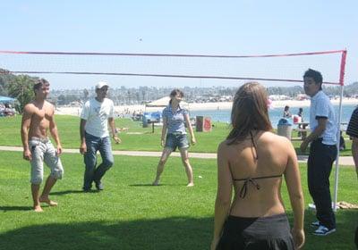 Students playing volleyball on Mission Bay.