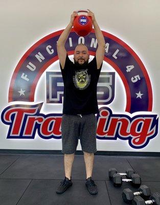 Me holding a kettle ball that weights 26 pounds. The amount of weight I've lost in 90 days.