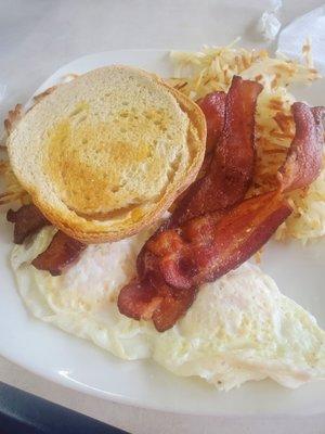 Eggs, hash browns, bacon and sourdough toast