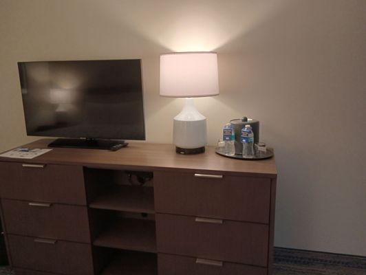 Flat screen TV above the dresser.