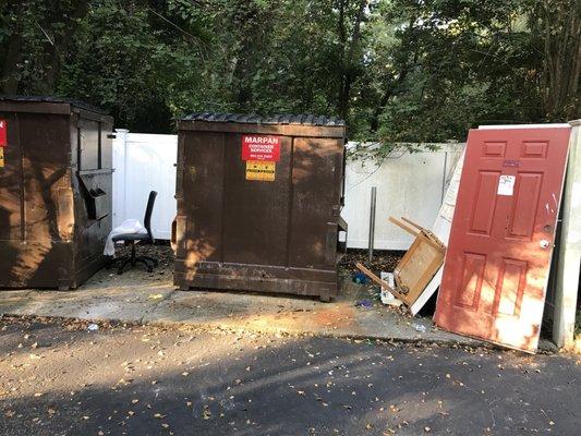 Trash piled around bins on August 9, 2018