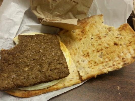 Dunkin Donuts breakfast sandwich.  Turkey sausage and fried egg on delicious multigrain flat bread.